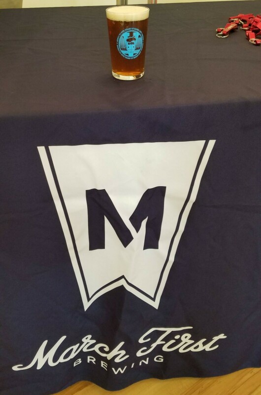 March First Brewing logo on tablecloth and beer sitting on table